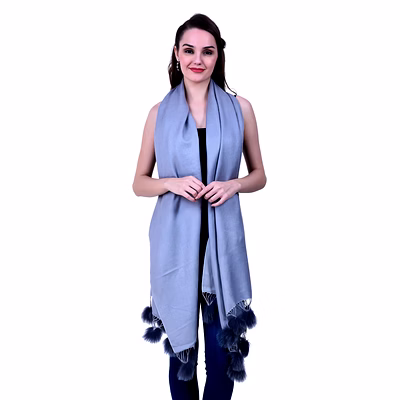 light blue woolen scarf with pom-pom tassel detailing draped over casual ensemble