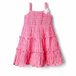 a pinky playful dress with smocked yoke and crinkled cotton bottom for ease with corsage attached to it