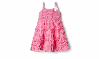 A pinky playful dress with smocked yoke and crinkled cotton bottom for ease with corsage attached to it