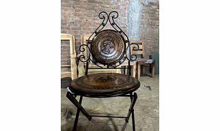 Wrought iron and wood folding chair in matte black and antique brown shade