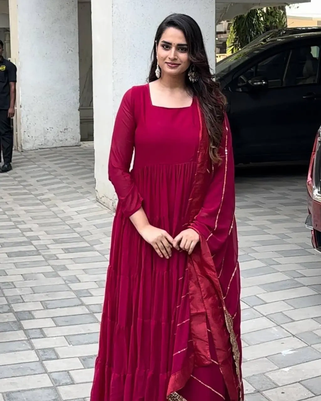 a woman in a red dress posing for a picture