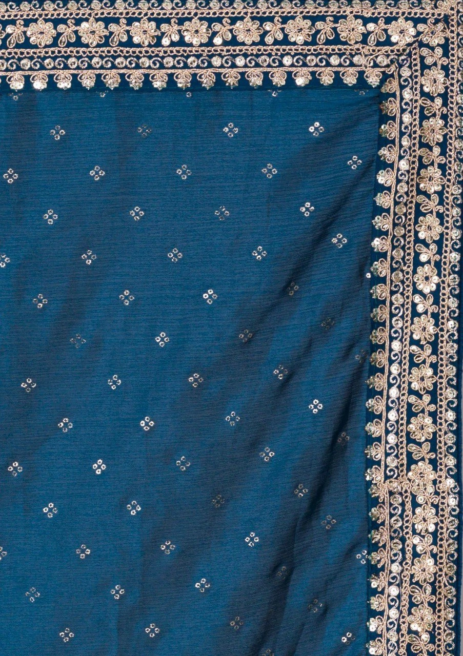 Peacock blue silk saree featuring stunning gold and silver zari and sequin embellishments.