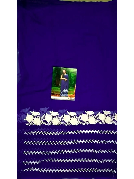 In a tranquil forest, a woman in a blue Georgette saree and Banglori silk blouse stands, showcasing 