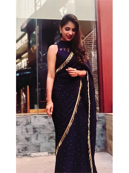 Elegant navy blue georgette saree complemented by a shimmering gold blouse, perfect for special occa