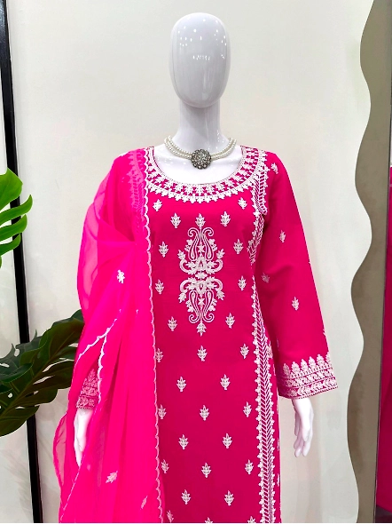 Stylish pink Roman silk suit adorned with white embroidery.