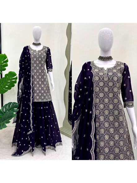 Navy blue lehenga suit with intricate embroidery, complemented by a matching dupatta draped elegantl