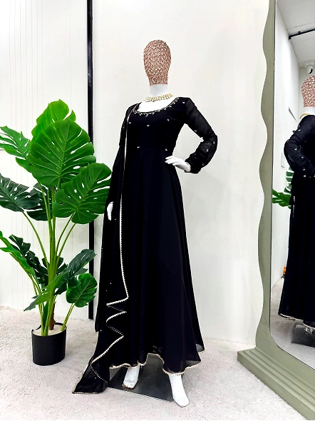Elegant black anarkali suit made of georgette, adorned with detailed gold embroidery.