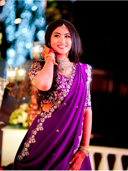 A stunning Indian bride wearing a bluish purple Vichitra lehenga choli set, showcasing intricate des