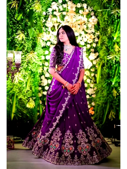An elegant Indian bride in a bluish purple Vichitra lehenga choli set, radiating beauty and cultural