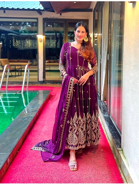purple Anarkali suit featuring elegant embroidery and sequins.
