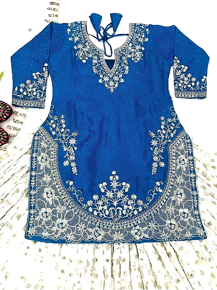 A woman in a beautiful cyan and pink lehenga, made from Chinon silk, suitable for joyous celebration
