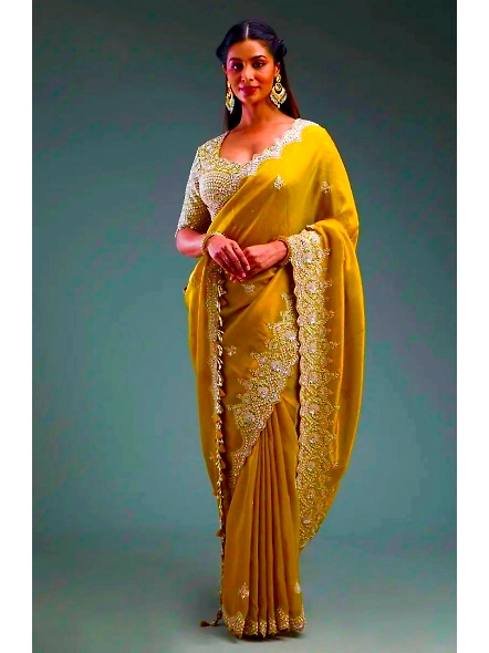 Yellow colored sari with premium crunchy fabric and intricate sequence work, showcasing elegance and