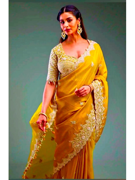 Elegant yellow sari featuring premium crunchy material and detailed sequence work, perfect for speci