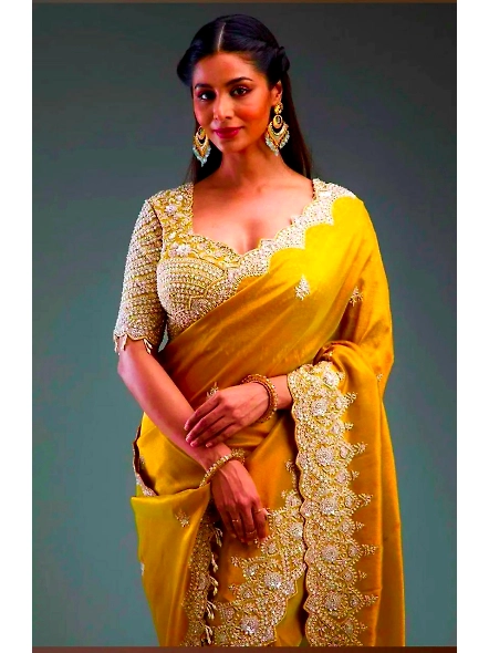 Beautiful yellow sari made of premium crunchy fabric, adorned with exquisite sequence work for a stu