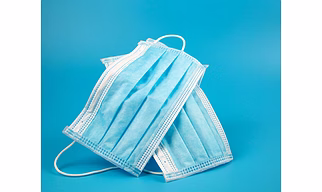 SURGICAL FACE MASK WITH MELT-BLOWN FILTER LAYER