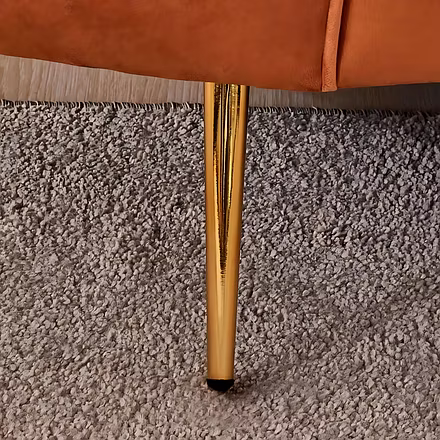 &quot;Gold metal leg detail of Woodkraft Studio orange velvet 3 seater sofa – premium designer couch