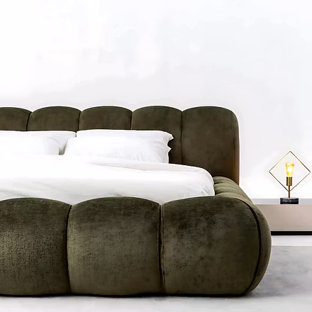 Side close-up of Cocoon upholstered bed showing soft padded frame and elegant headboard design.
