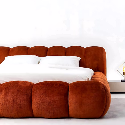 Side close-up of Cocoon upholstered queen size bed in vibrant red upholstery showing soft padded fra