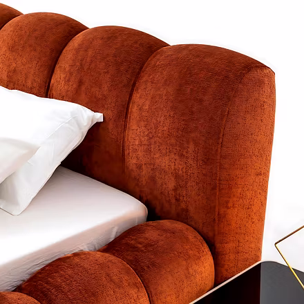 Side close-up of Cocoon upholstered bed showing soft padded frame and elegant headboard design.
