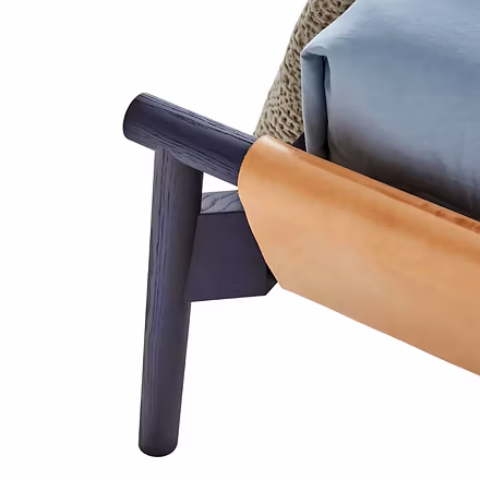 Close-up view of teakwood bed frame joint with tan leather detailing for premium modern bedroom déco