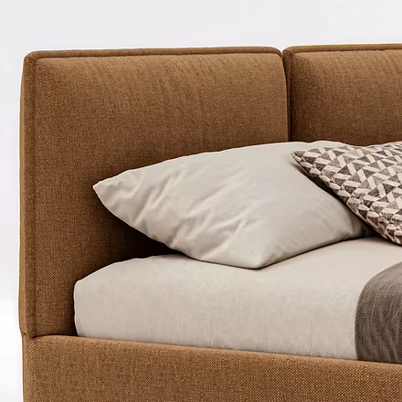 Close-up of Resto upholstered bed featuring plush brown fabric, sturdy wooden frame, and slim black 