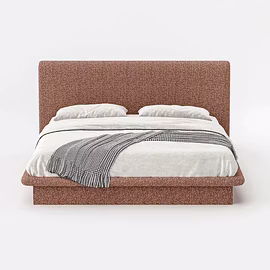 Front-facing rust fabric Drift upholstered bed with white linen and patterned throw, sleek low profi