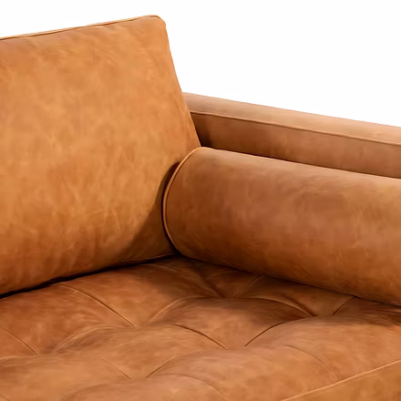 Close-up of tan Alba L Shape Sofa leather cushion and bolster pillow