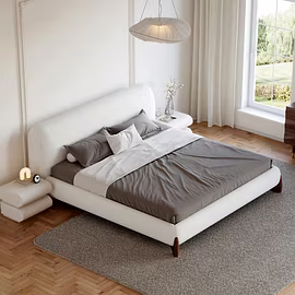 Contemporary bedroom featuring a white Ashlie upholstered bed with gray bedding, highlighted by a br