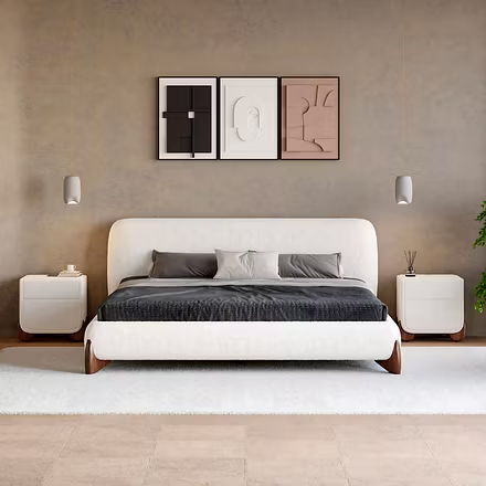 Front view of a white Ashlie upholstered bed with gray linens against a textured gray wall with a de