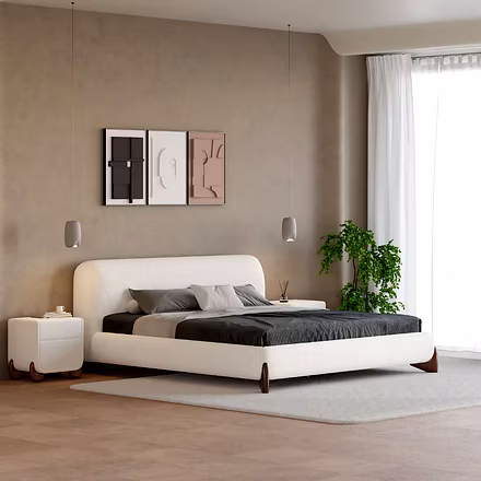 Angled view of a white Ashlie upholstered bed with gray bedding in a modern room with pendant lights
