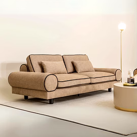 Prado 3 seater sofa in beige linen-look upholstery with black piping and round arm bolsters, styled 