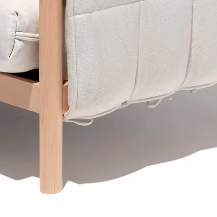 (Leg &amp; Base): Close-up of sofa leg showcasing smooth teakwood finish and fabric fold detail.