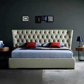 Bedroom scene featuring Archies upholstered bed with tufted headboard, layered bedding and nightstan