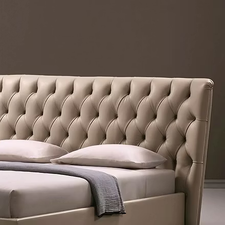 Detail of rounded platform base and mattress on Archies upholstered bed, showing low profile silhoue