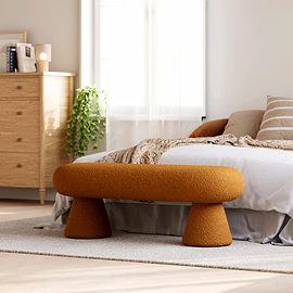 Lifestyle scene: Terra bench styled in sunlit bedroom with wooden dresser and plants — customizable 