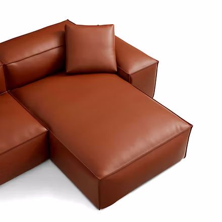 brown: “Close-up of Opulence sofa cushions in brown leather showing piped seams and plush seat”