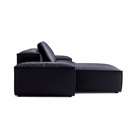 black: “Side profile of Opulence L shape sofa in black leather showing low-profile chaise”