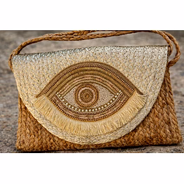 artisanal woven jute sling bag with metallic golden yellow color flap, intricate evil eye beadwork, and bohemian fringe detailing for international markets