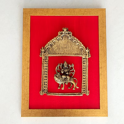 majestic brass prabhavali with goddess durga framed on deep red raw silk . frame height 45 cm x width 35 cm weight: 3.0 kg pif-2614