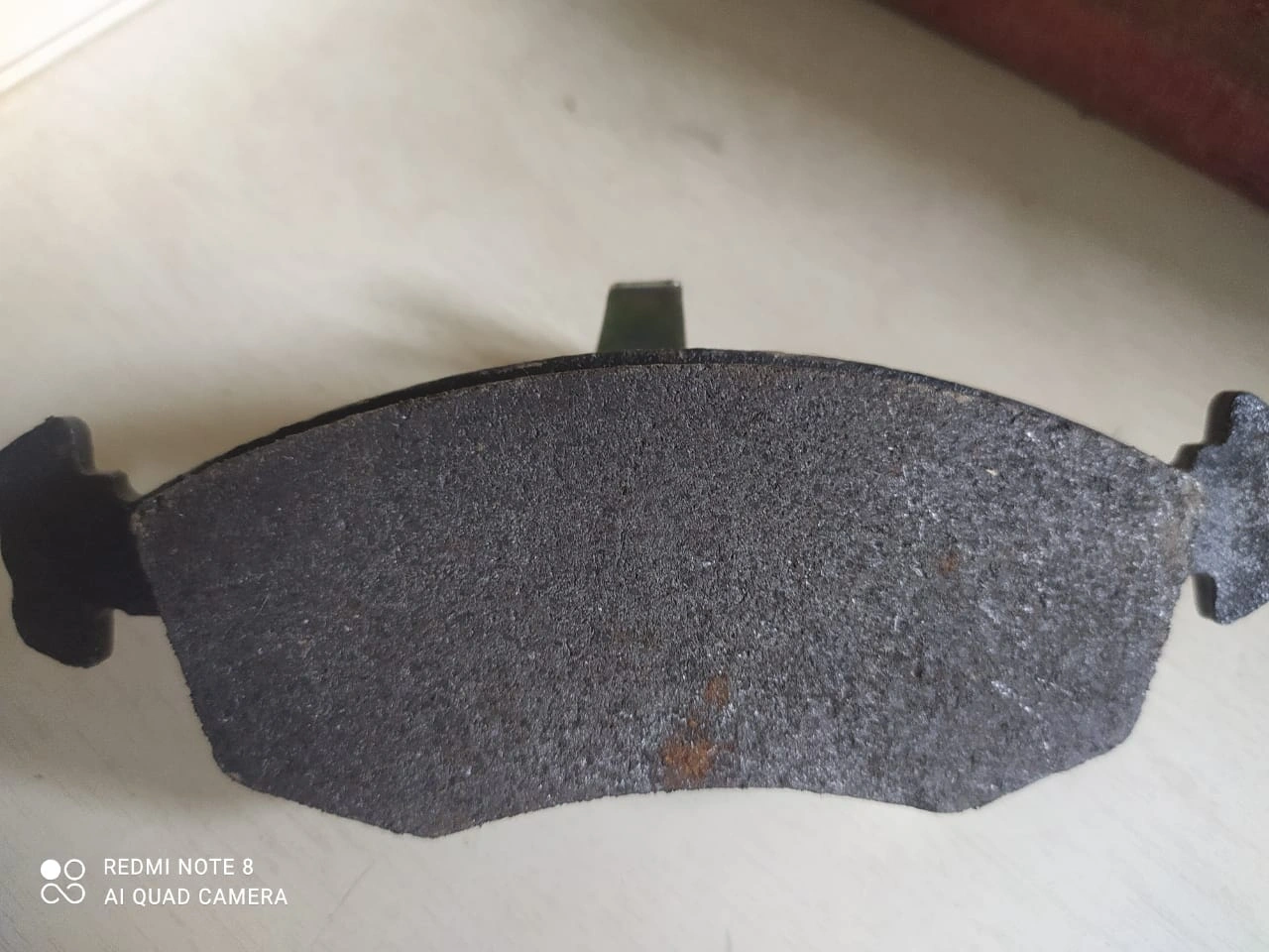 Brake Pad - Friction material used in vehicle braking systems for slowing and stopping the vehicle.