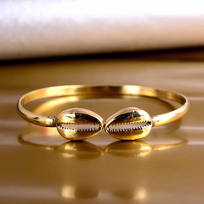 artistically crafted brass cowrie bracelet cuff