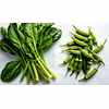 Fresh spinach leaves and lady finger (okra) pods on a rustic wooden table,