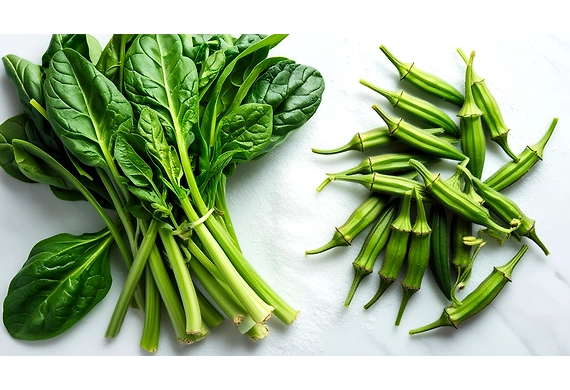 Fresh spinach leaves and lady finger (okra) pods on a rustic wooden table,