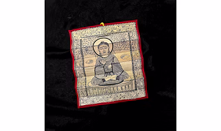 Palm leaf engraving of meditating Buddha